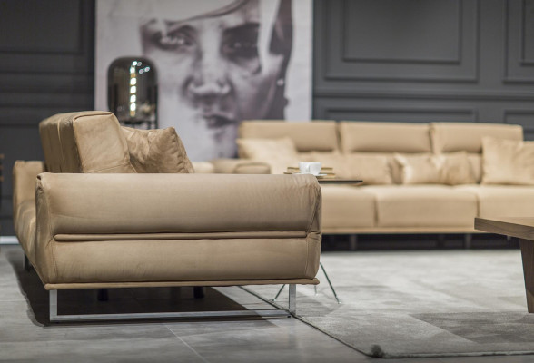 Beige three-seater sofa with cushions