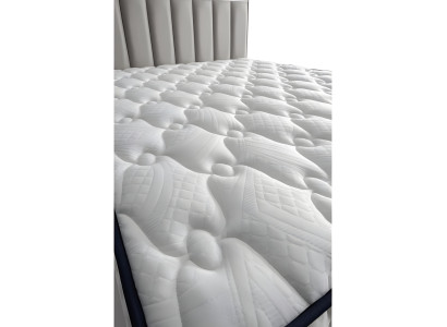 Modern gray bed made of fabric and wood with mattress