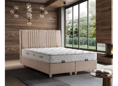Elegant bed with pillow in light beige fabric and wood