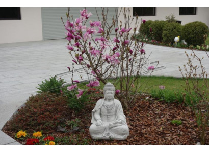 Buddha sculpture in stone look. Large statue figure for garden decoration.