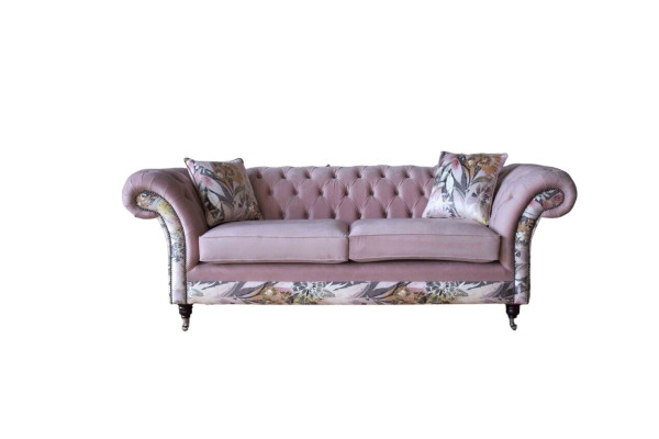 A lively three-seater Chesterfield sofa with a delicate pink floral pattern