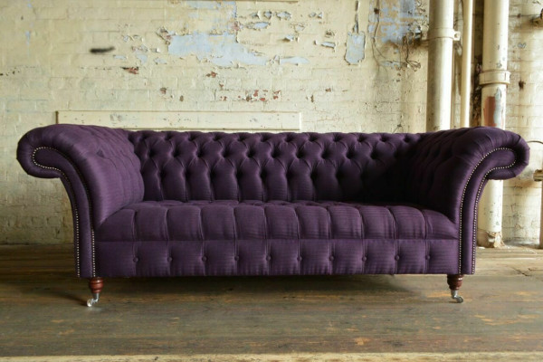 Modern purple Chesterfield three-seater living room sofa.