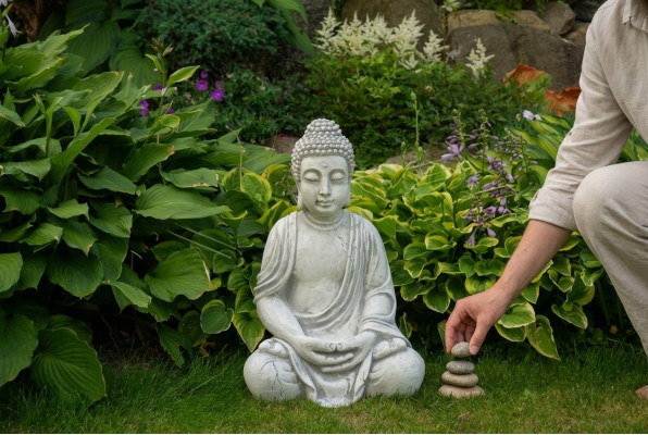 Buddha statue figure in stone look. Large sculpture for decorative garden.