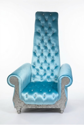 A refined armchair with a high backrest and a design reminiscent of a Voltaire chair.