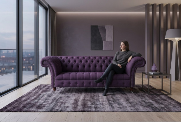 Modern purple Chesterfield three-seater living room sofa.