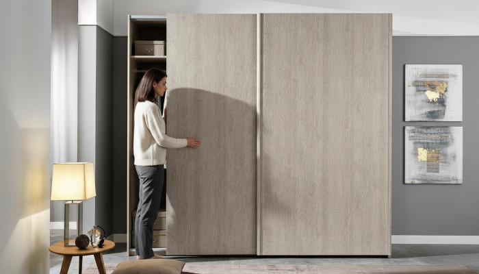 Modern wardrobe with sliding doors for the bedroom made of natural wood
