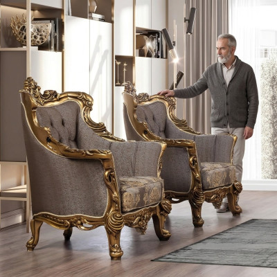 A luxurious classic wingback chair in dark gray with golden baroque design by Chesterfield