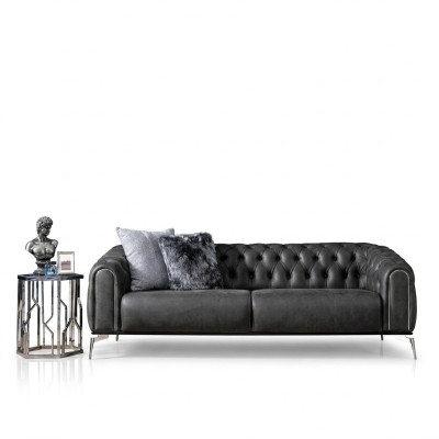 Black straight four-seater sofa in Chesterfield style for the living room.