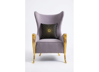 Luxurious armchair with decorative elements and gilded legs
