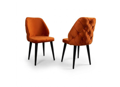 Padded orange Chesterfield wooden chair on black legs the dining room