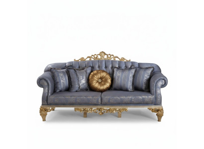 Sophisticated classic sofa in Chesterfield design for the living room with golden cushions.