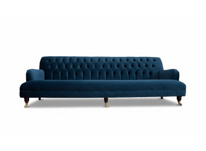 Luxurious designer sofa in Chesterfield style with four seats in blue color.