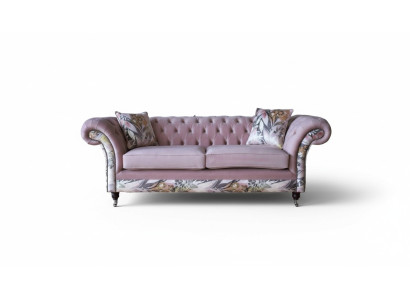 A lively three-seater Chesterfield sofa with a delicate pink floral pattern
