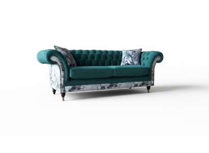 A lively three-seater Chesterfield sofa in a delicate emerald color with a floral pattern.