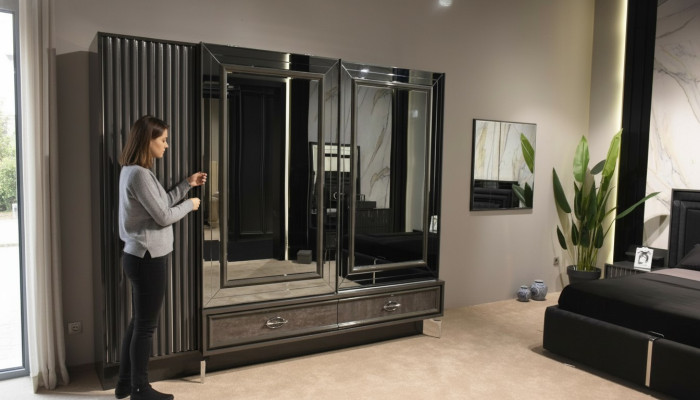 Designer wooden wardrobe with mirrored doors and drawers bedroom
